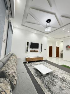 a living room with a couch and a tv at Dar AL-HANAA in Nouakchott