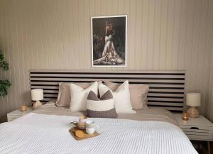 a bedroom with a bed with a tray on it at Fjordheart Srbvg 1 in Hyllestad