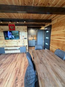 a conference room with a large wooden table and chairs at Stone Throne Retreat in Drušići