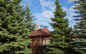 a gazebo with a sign on top of it between two trees at AZIMUT Hotel Kostroma in Kostroma