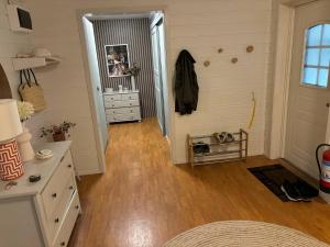 a room with a hallway with a dresser and a door at Fjordheart Srbvg 1 in Hyllestad +7 photos