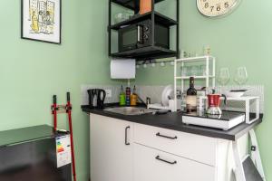 a kitchen with a sink and a counter top at Minicasa Il Salone di Gino in Potenza