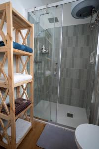 a shower with a glass door in a bathroom at Minicasa Il Salone di Gino in Potenza +7 photos