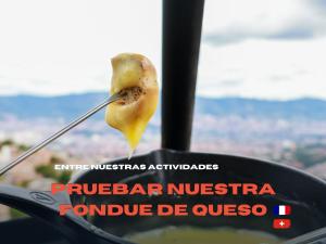 a spoon with a piece of food sticking out of a window at Hostal Del Cielo in Medellín