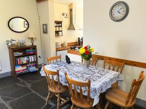 a dining room table with a vase of flowers on it at Drovers Retreat in Llandrindod Wells +46 photos