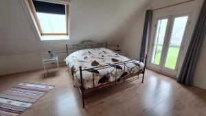 a bedroom with a bed in a room with a window at UNESCO de Beemster, vakantiewoning in Noordbeemster