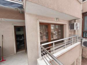 a balcony of a building with a window at Apartment in the Center 1 in Varna City