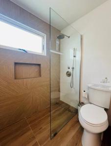 a bathroom with a toilet and a glass shower at Seaside Villa Culebra in Culebra