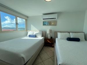 a bedroom with two beds and a window at Seaside Villa Culebra in Culebra