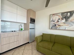 a living room with a green couch in a kitchen at Seaside Villa Culebra in Culebra