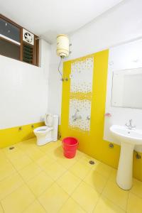 a bathroom with a toilet and a sink at The Royal Palace in Lucknow