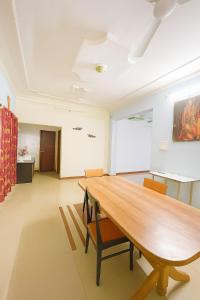 a conference room with a wooden table and chairs at The Royal Palace in Lucknow