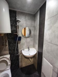 a bathroom with a sink and a toilet at Apartment in the Center 1 in Varna City +48 photos