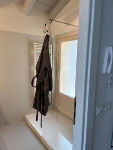 a robe hanging in a bathroom with a window at Dream View Lake Como in Carate Urio