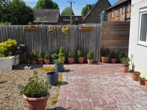 a garden with potted plants on a fence at Corner Lodge in Eltham