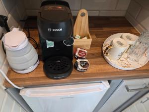 a black coffee maker on a wooden counter top at Corner Lodge in Eltham