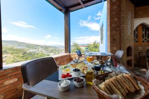 a table with food on it on a balcony at Riad Seddiki in Chefchaouen