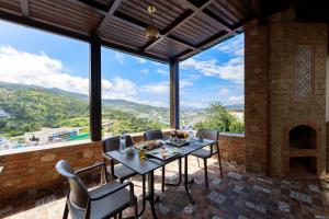 a patio with a table and chairs and a fireplace at Riad Seddiki in Chefchaouen