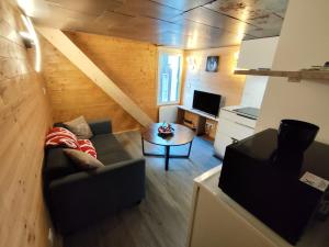 a living room with a couch and a table at L'instant parental in Ustou