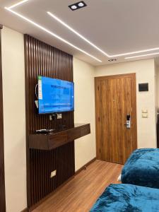a room with two beds and a flat screen tv at Montaza World inn in Alexandria
