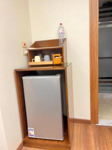 a small refrigerator in a corner of a room at Montaza World inn in Alexandria