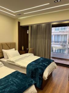 a hotel room with two beds and a window at Montaza World inn in Alexandria +46 photos