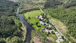 an aerial view of a farm in the middle of a river at Cottage - Sleeps 5 - Garden - River Side in Garve