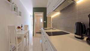 a kitchen with a sink and a counter top at Villa Porto in Mlini +57 photos