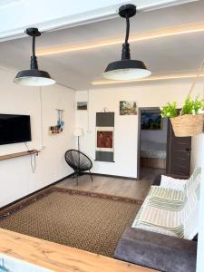 a living room with two lights hanging from the ceiling at Квартиры под соснами in Cholpon-Ata