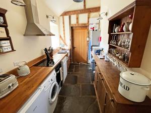 a kitchen with a sink and a stove top oven at Drovers Retreat in Llandrindod Wells