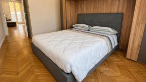 a bedroom with a large bed with a black headboard at Attico Matteotti Sanremo Luxury Terrace Apartment in Sanremo +17 photos