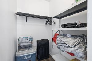 a room with a closet with a bed and a shelf at Clearwater Paradise w Hot Tub-Backyard Bliss Near Beach & Hot Spots in Clearwater