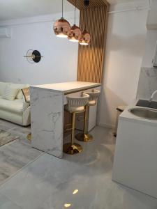 a kitchen with a counter and a table and a sink at Apartament DeLux cu Jacuzzi Caciulata in Căciulata +12 photos