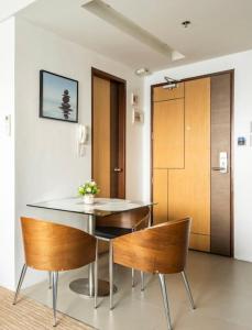 a dining room with a table and chairs at R2 condotel tower in Manila
