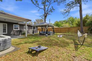 a backyard with a table and a gazebo at Clearwater Paradise w Hot Tub-Backyard Bliss Near Beach & Hot Spots in Clearwater