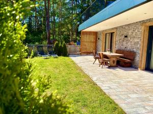 a patio with a table and chairs and a bench at Alpenchalet Oetztal in Oetz