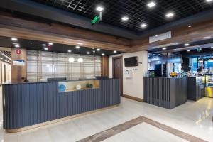 a lobby with a reception desk in a building at Wyn Residence Batumi in Batumi
