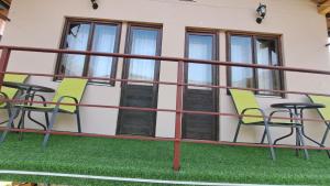 a group of chairs and tables on a balcony at Kod mosta in Pirot +2 photos