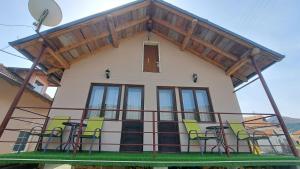 a house with a balcony with chairs on it at Kod mosta in Pirot