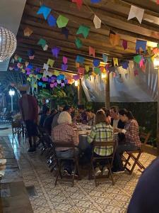 a group of people sitting at tables in a restaurant at Suites Prime Itamambuca in Ubatuba +41 photos