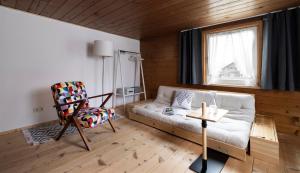 a living room with a couch and a chair at Gästehaus Kaufmann in Mellau