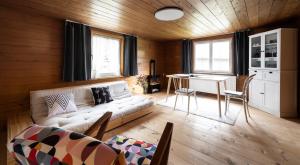 a living room with a white couch and a table at Gästehaus Kaufmann in Mellau