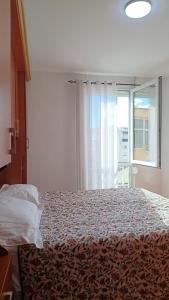 a bedroom with a bed and a large window at Cozy Apartment, Free Parking near Dajti Cable Car, Bunk'Art in Tirana