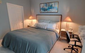 a bedroom with a bed and a desk and a chair at Turnkey Tranquility with Marina & Intercoastal views in Lantana