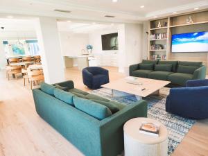 a living room with a couch and a table at Turnkey Tranquility with Marina & Intercoastal views in Lantana