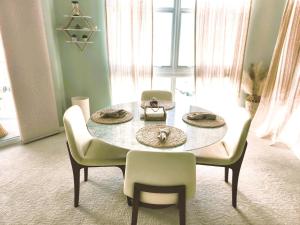 a dining room table with two chairs and a table and chairs at Turnkey Tranquility with Marina & Intercoastal views in Lantana