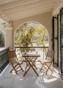 a table and two chairs on a balcony at Mediterranean Haven in Paleokastritsa