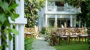 a table and chairs in front of a house at Luxury Private Pool Villas at Village Danang Resort in Danang