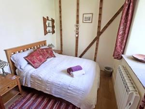 a bedroom with a bed with a towel on it at Drovers Retreat in Llandrindod Wells