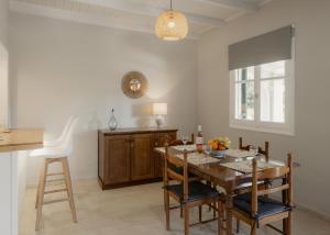 a dining room with a wooden table and chairs at Mediterranean Haven in Paleokastritsa